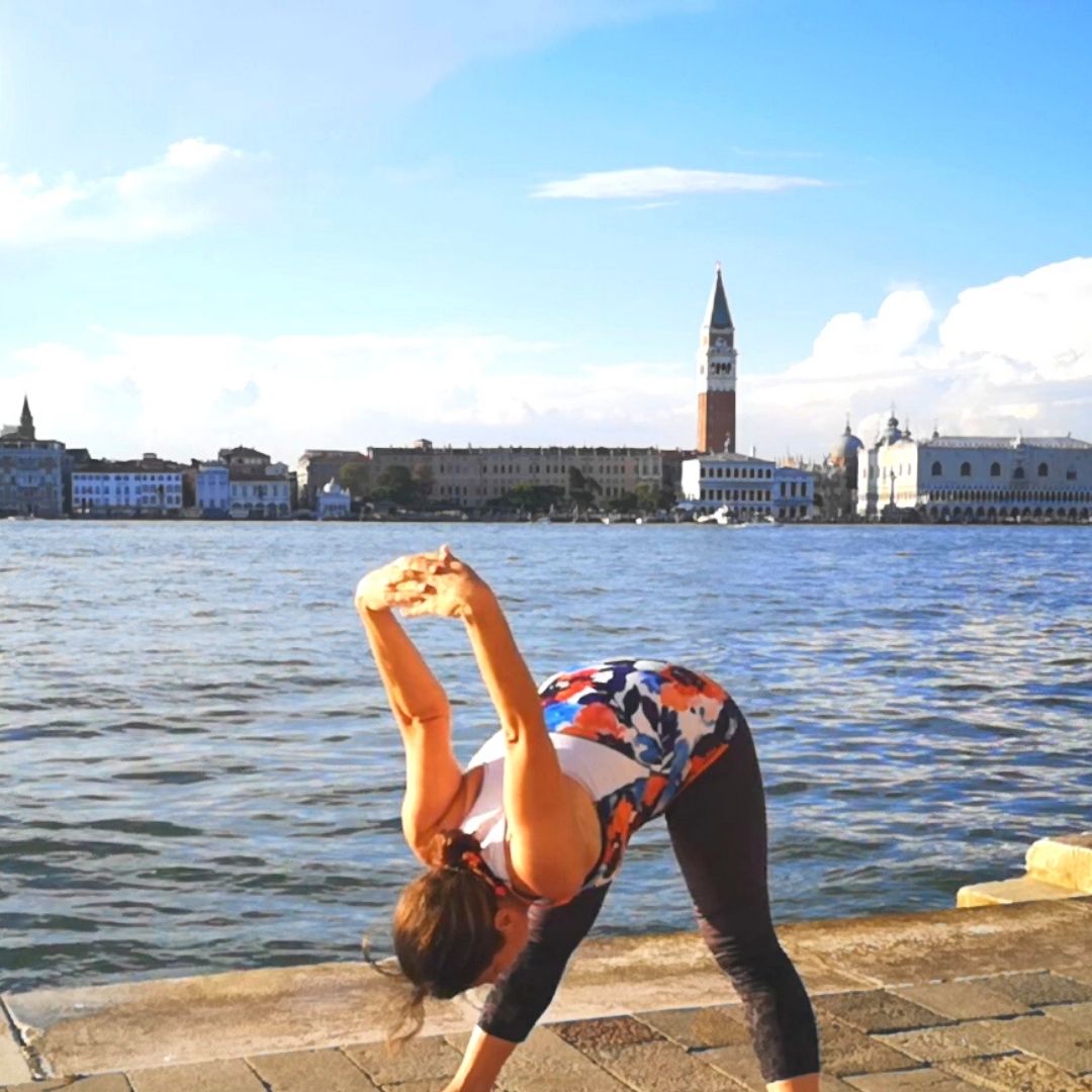 Forward Fold yoga pose in Venice setting